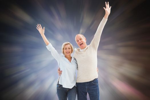 Happy mature couple cheering at camera against dark abstract light spot design