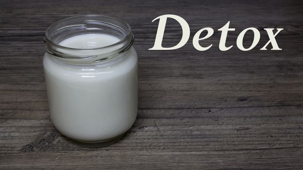 Greek yogurt, milk in a glass jar on a wooden table, detox, diet