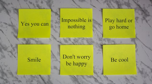 Motivational words on colored sheets of paper. Creativity and art. Study, education, work. Office, school, University. Stationery.