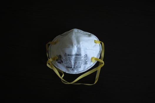 Bangkok, THAILAND - Mar 26, 2020 : N95 mask for protection against pollution, virus, flu and coronavirus (Covid-19). Protection pm 2.5. Air face mask. Medical Doctor mask on Black background. Copyspace for artwork . 