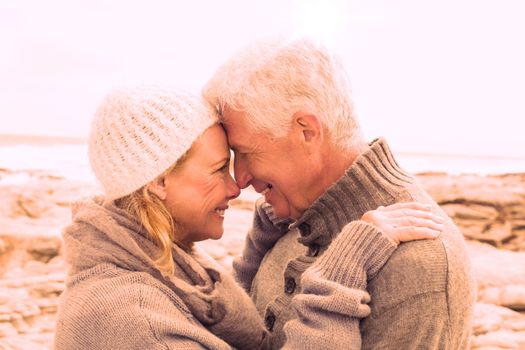 Side view of a romantic senior couple together on a rocky beach