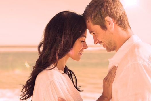 Romantic couple relaxing and embracing on the beach during the summer