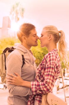 Young tourist couple about to kiss on a sunny day in the city