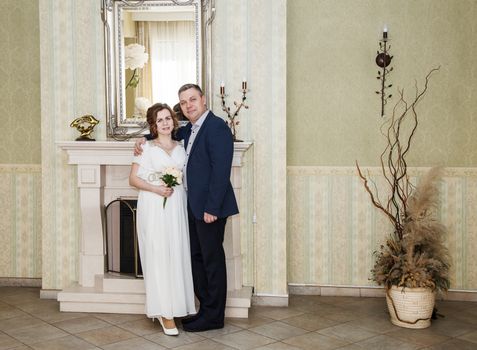 couple of lovers standing in the hall of prefecture at marriage