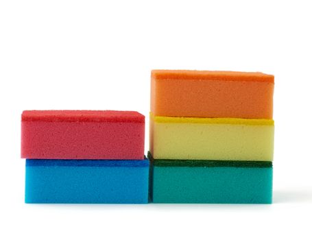 stack of new multi-colored kitchen sponges for washing dishes isolated on a white background