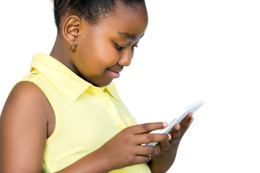 Close up portrait of cute little african girl with ponytail looking at digital tablet.Side view of kid Isolated on white background.