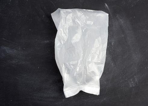 white transparent plastic bag for products on a black background, top view