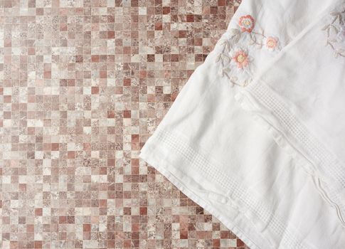 white kitchen towel on a kitchen brown surface, top view, copy space