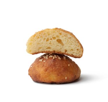 baked round bun with sesame seeds isolated on a white background, home baking