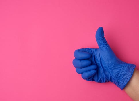 doctor in a white coat shows with his hand a gesture like, wearing blue latex medical gloves, close up