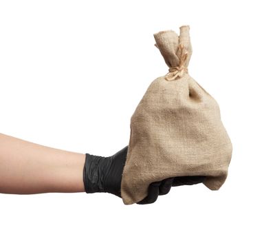 male hand in black latex glove holds a full canvas bag on a white background, close up