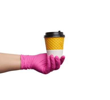 hand in a pink latex glove holds a paper disposable cardboard cup and plastic cover on a white background, safe and contactless delivery of on-line orders during epidemics