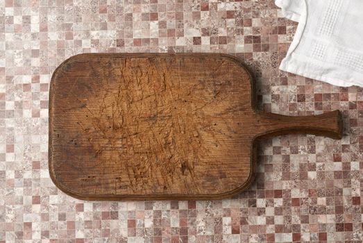 empty brown very old vintage kitchen cutting board with handle, top view