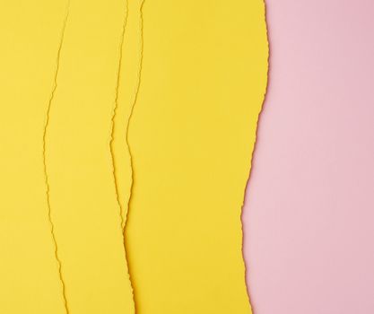 background of layered yellow torn paper with a shadow on a pink background, backdrop and template for designer