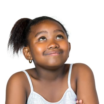 Close up portrait of cute little african girl with wondering facial expression looking up.Isolated on white background.