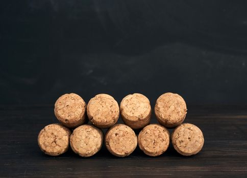 stack of corks for glass wine and champagne bottles on wooden background, copy space