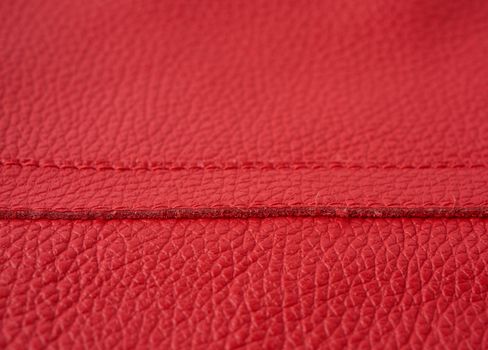 natural bright red cowhide texture, full frame, scarlet color, close up