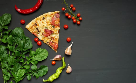 triangular piece of baked pizza with mushrooms, smoked sausages, tomatoes and cheese, black background, flat lay, copy space