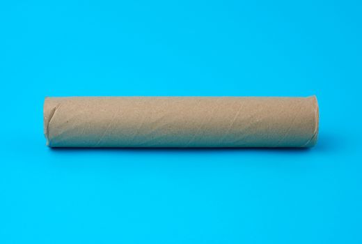 brown paper towel from a roll of kitchen towels, object on a blue background