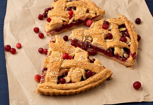 slice pie cranberry. Blue wooden background. Delicious fruit cake.