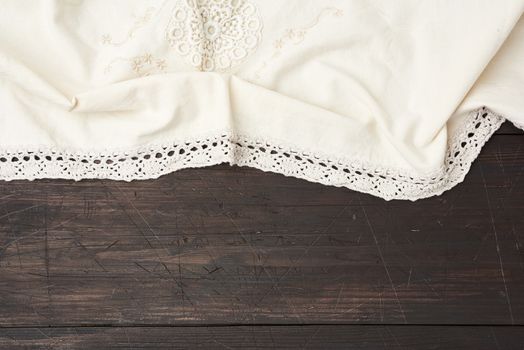 kitchen textile towel folded on a gray wooden table from old boards, top view, empty space. Rustic texture. Retro background