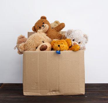 brown cardboard box filled with soft toys, concept of charity and assistance to needy children