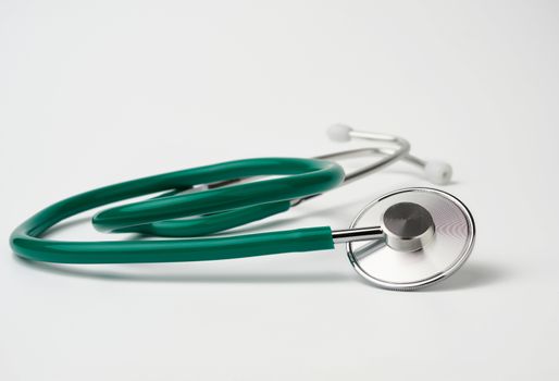 green medical stethoscope on white background, medical item for measurement