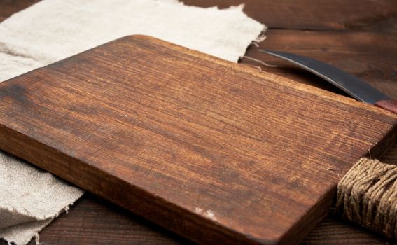 very old empty wooden rectangular cutting board and knife, close up