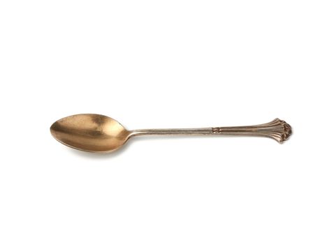 silver vintage small coffee spoon for pouring sugar isolated on a white background, close up