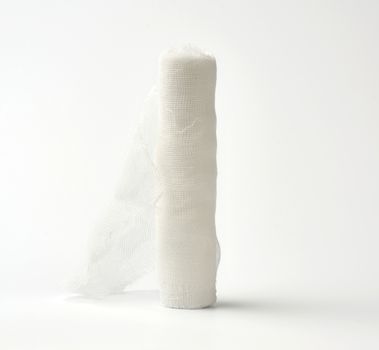 roll of white gauze bandage on a white background,  medical item for dressing human limbs