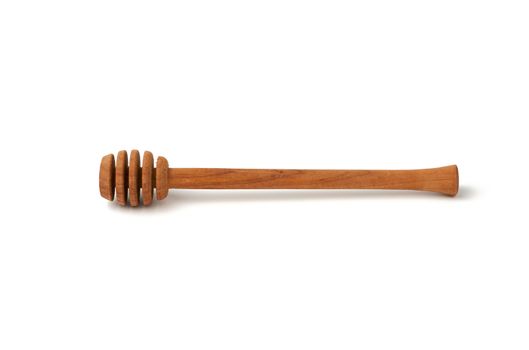 wooden stick for stirring honey isolated on a white background, close up