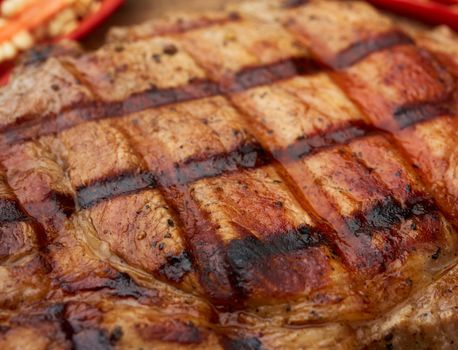 texture of grilled on the grill a piece of pork meat on the rib, macro