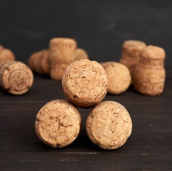 stack of corks for glass wine and champagne bottles on wooden background, close up