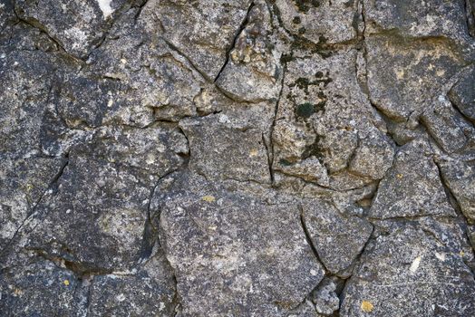 texture of the old gray masonry of gray stones of various shapes, full frame