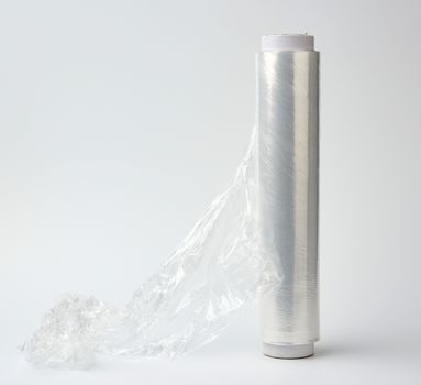 big roll of wound white transparent film for wrapping food, white background, close up