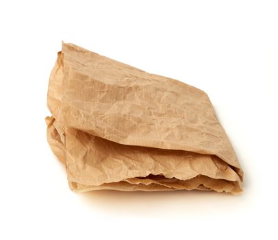 folded brown crumpled sheet of parchment paper isolated on white background, element for designer