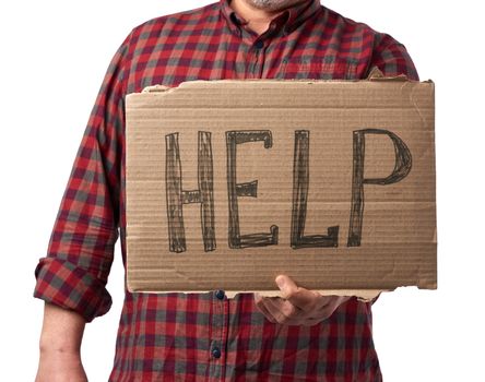 adult man in a red plaid shirt holds a piece of cardboard with the inscription help, mutual assistance concept, homeless, financial crisis