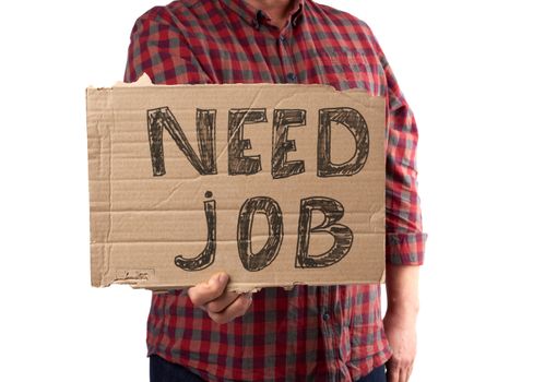 man in a plaid shirt and jeans holds a piece of paper with the inscription need job, concept of unemployment against the backdrop of the global crisis, fired employee, man is isolated on a white background