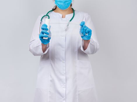 medic woman in white coat and mask holds a twisted gauze bandage for dressing wounds, white background