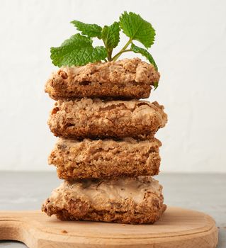 stack of baked Krakow meringue cookies on a wooden board, delicious dessert of whipped egg whites and almond flour