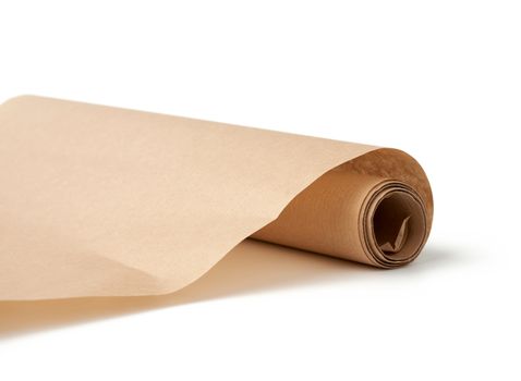 twisted roll of brown parchment paper isolated on a white background, wax baking paper, close up
