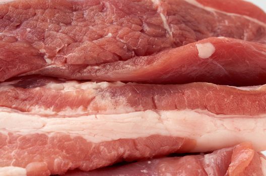 stack of pork raw meat, tenderloin with layers of fat, barbecue ingredient