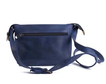 blue leather small handbag with a long handle isolated on a white background, fashionable female accessories