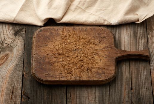 empty brown very old vintage kitchen cutting board with handle, top view