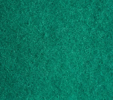 green texture of a kitchen sponge with fibers, full frame, macro