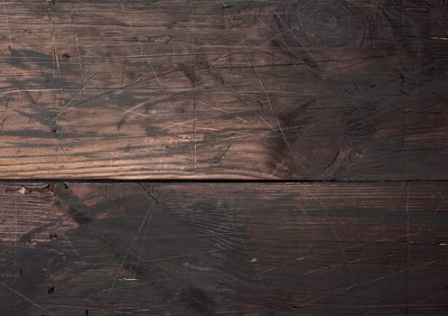 Background of brown wooden boards with cracks, scuffs. Backdrop for compositions, rustic