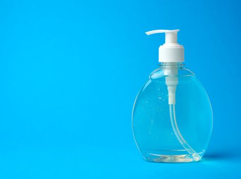 transparent plastic bottle with a sanitizer for disinfecting hands on a blue background, a place for inscription