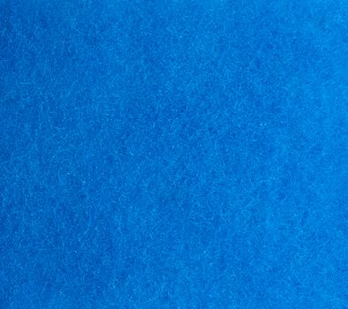 blue texture of a kitchen sponge with fibers, full frame, macro