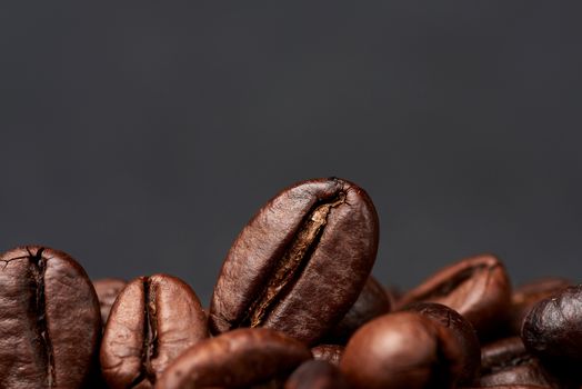 roasted coffee grains on a black background, close up