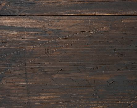 Background of brown wooden boards with cracks, scuffs. Backdrop for compositions, rustic